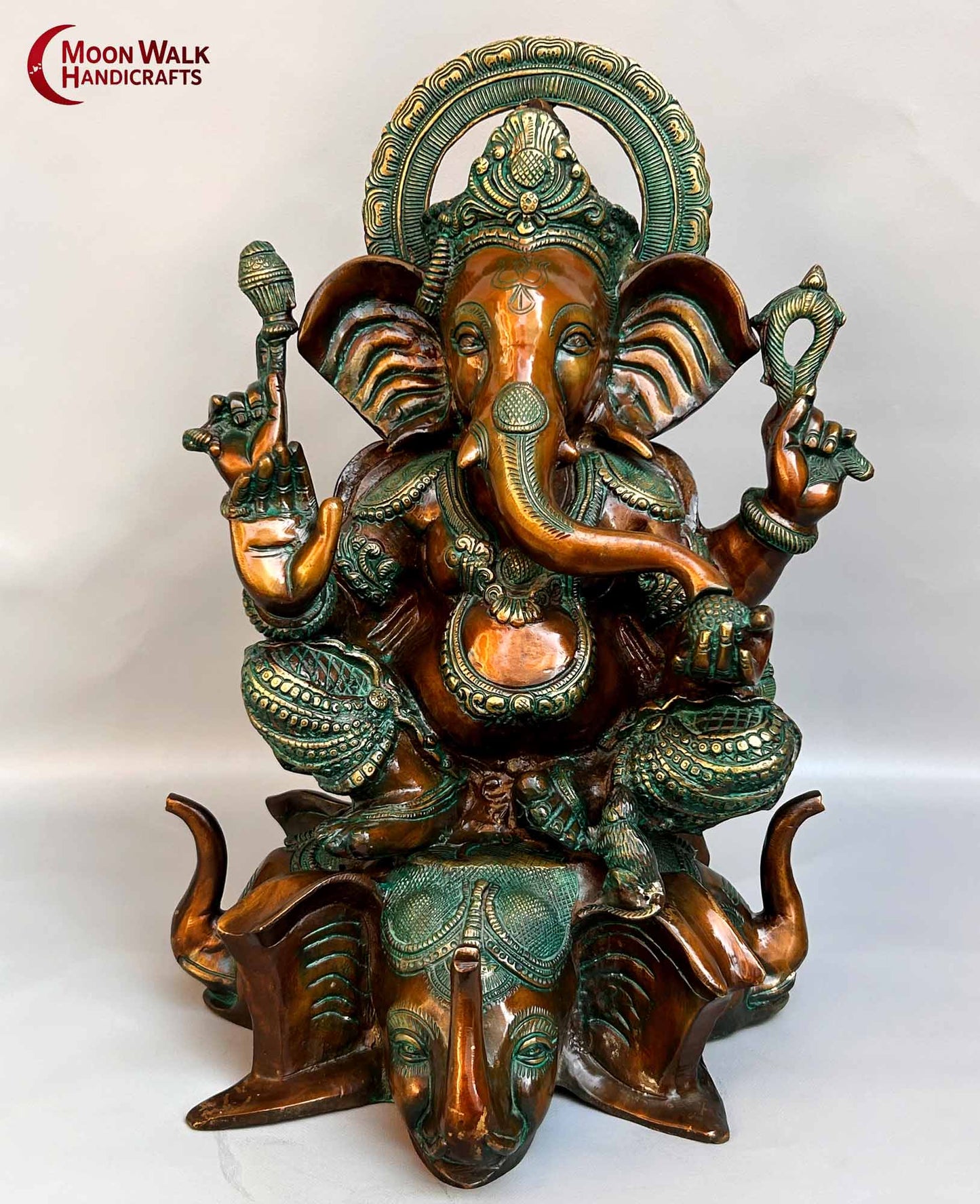 Rustic Brass Ganesh Statue seated on base with 3 Elephant Heads with trunks.
