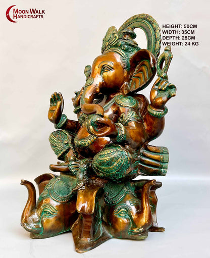 Rustic Brass Ganesh Statue seated on base with 3 Elephant Heads with trunks.