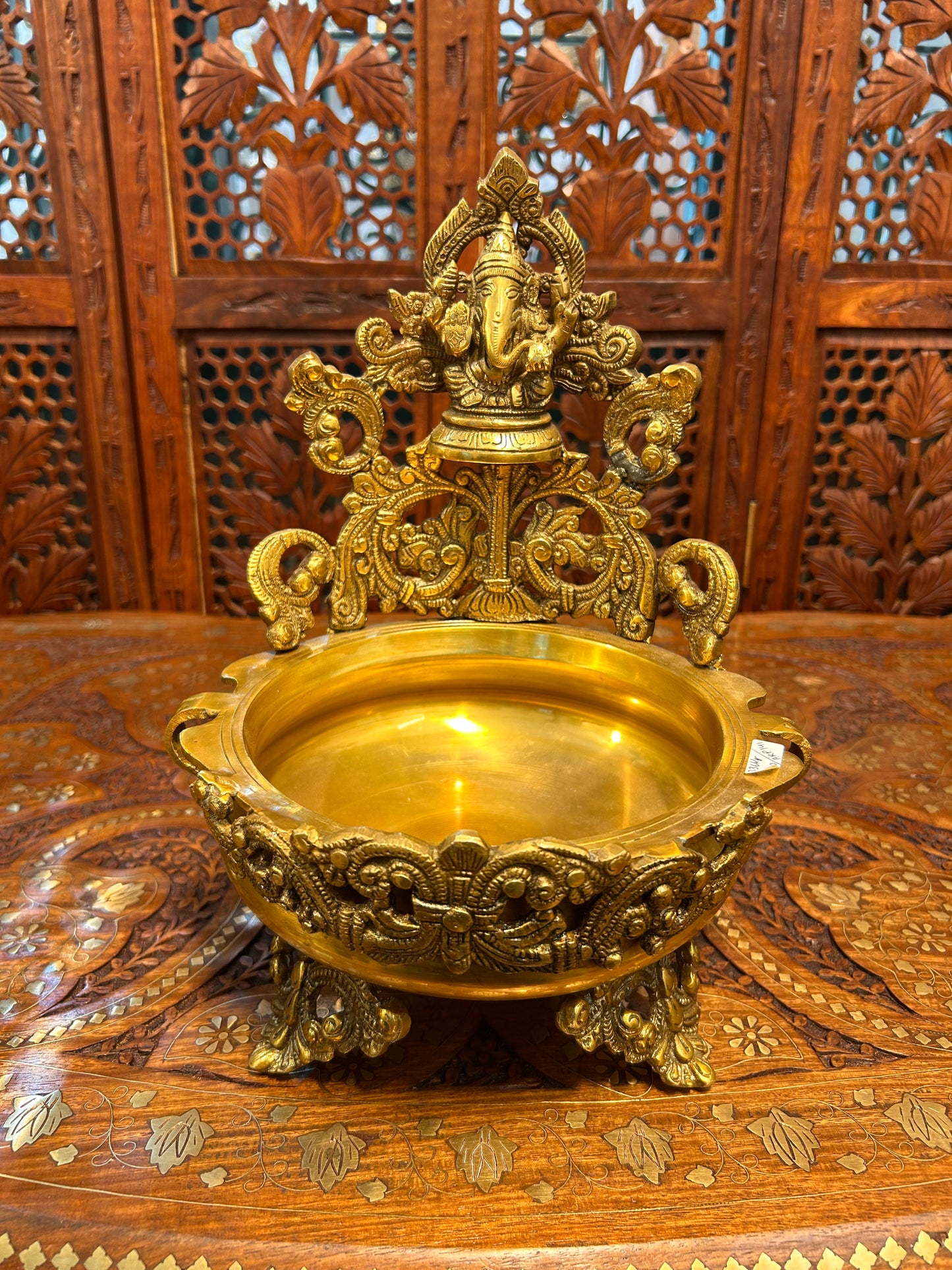 Exquisite brass Ganesha urli bowl with intricate carvings, ideal for home decor, pooja, festivals, or gifting, adding elegance and divine