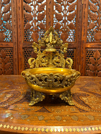 Exquisite brass Ganesha urli bowl with intricate carvings, ideal for home decor, pooja, festivals, or gifting, adding elegance and divine